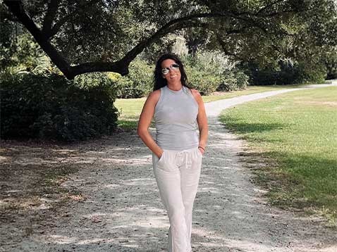 Smiling woman posing for a photo in a park