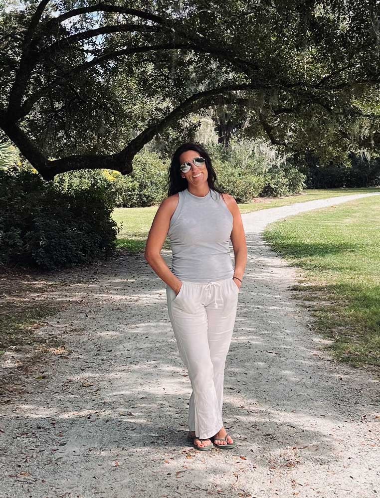 Smiling woman posing for a photo in a park